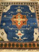 A Large Turkish hand knotted carpet, the blue field with star medallion enclosed by a guarded border