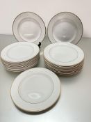 A set of 25 Wedgwood china dinner plates with simple gold banded border, show little to no signs