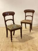 A pair of mid 19th century mahogany chairs, each with scrolled rail back, floral needlework seat