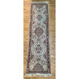 A Persian Tabriz runner rug, hand knotted, the ivory ground decorated with stylized foliate and