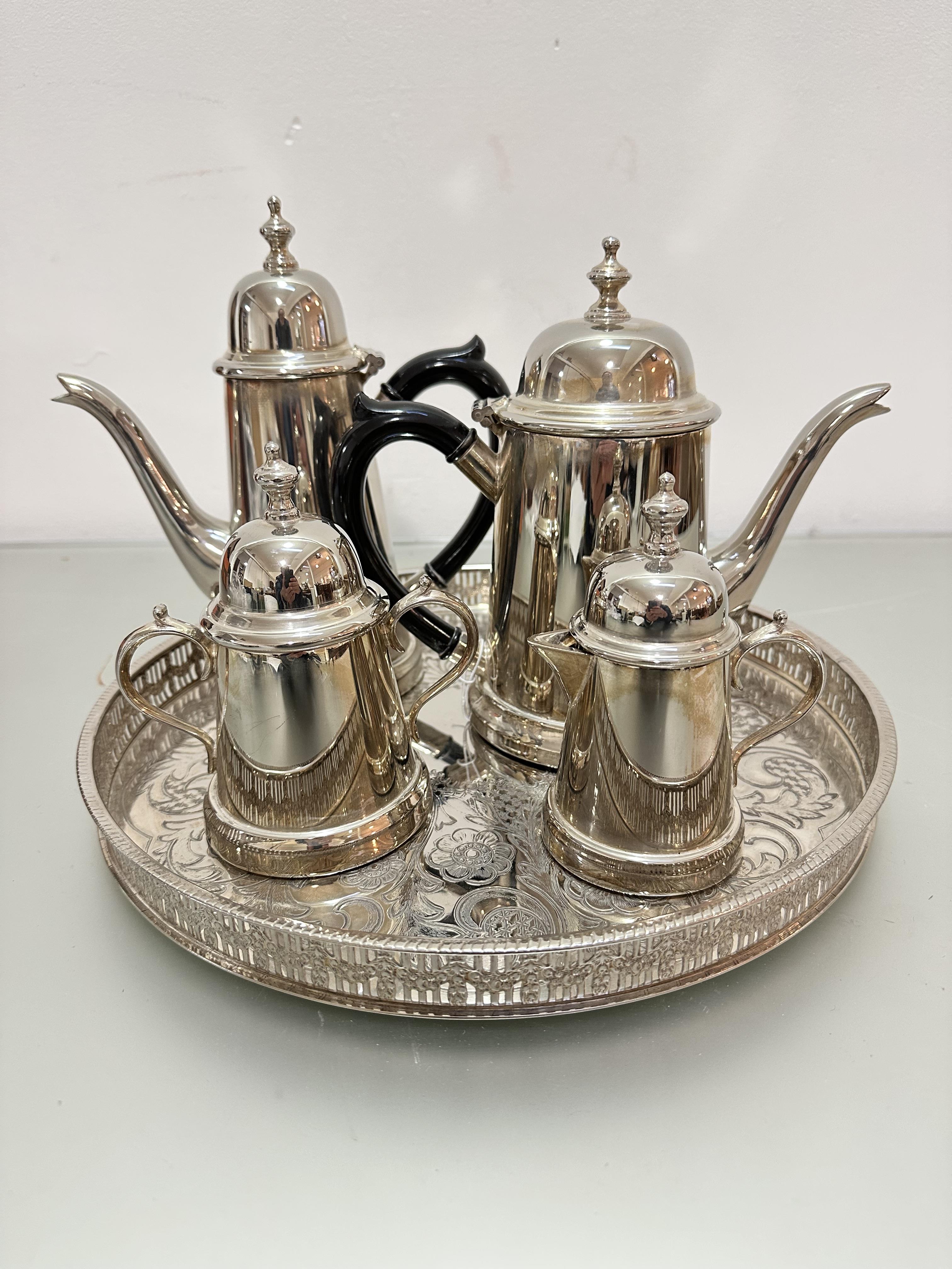 An Epns circular galleried tea tray with engraved decoration, (h 3cm x d 31cm) and a 4-piece Epns