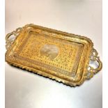 An Indian brass two handled peacock decorated tray of rectangular form (h 2cm x 53cm x 28cm) with