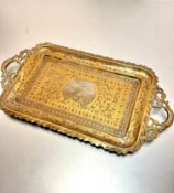 An Indian brass two handled peacock decorated tray of rectangular form (h 2cm x 53cm x 28cm) with