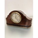 A 1930's walnut mantel clock with silver dial and arabic numerals and beaded border of crescent