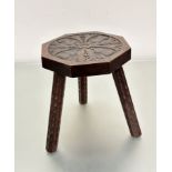 A Scottish oak octagonal stool with thistle and leaf carved design to top, on carved dart