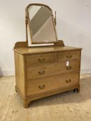 An Early 20th century walnut dressing chest, with swing mirror over two short and two long graduated