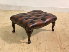 A deep buttoned and studded oxblood leather upholstered foot stool, raised on cabriole supports,