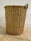 A large cylindrical wicker twin handled log basket, H83cm, W70cm