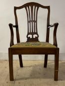 An early 19th century elm and oak carver chair, with splat back, swept open arms, drop in seat