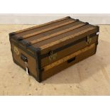 An early 20th century wood and metal bound steamer trunk, with carry handle to each end, H334cm,