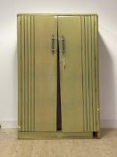 An Art Deco period green painted oak wardrobe, the doors with turned and wrought handles enclosing