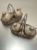 A pair of white metal baskets containing two pairs of Partridge condiments, (h 10cm x 15cm, h 9cm