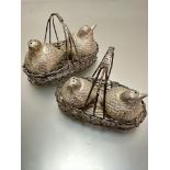 A pair of white metal baskets containing two pairs of Partridge condiments, (h 10cm x 15cm, h 9cm