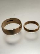A 9ct gold wedding band, size u/v, weighs 5.45 grammes, and an 18ct gold wedding band, size j,