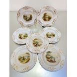 A set of seven English Victorian china dessert plates, the centres with hand painted landscape