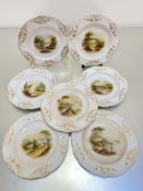 A set of seven English Victorian china dessert plates, the centres with hand painted landscape