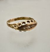 An Edwardian 18ct gold five-stone diamond ring, set with rose cut diamonds, some a/f, in open work
