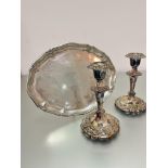 A pair of Epns baluster stem candlesticks decorated with floral and scroll chasing, (h 18cm x d