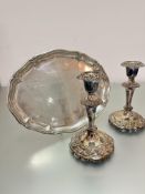 A pair of Epns baluster stem candlesticks decorated with floral and scroll chasing, (h 18cm x d
