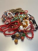 A collection of necklaces including stained treen bead necklace, an amber glass faceted bead