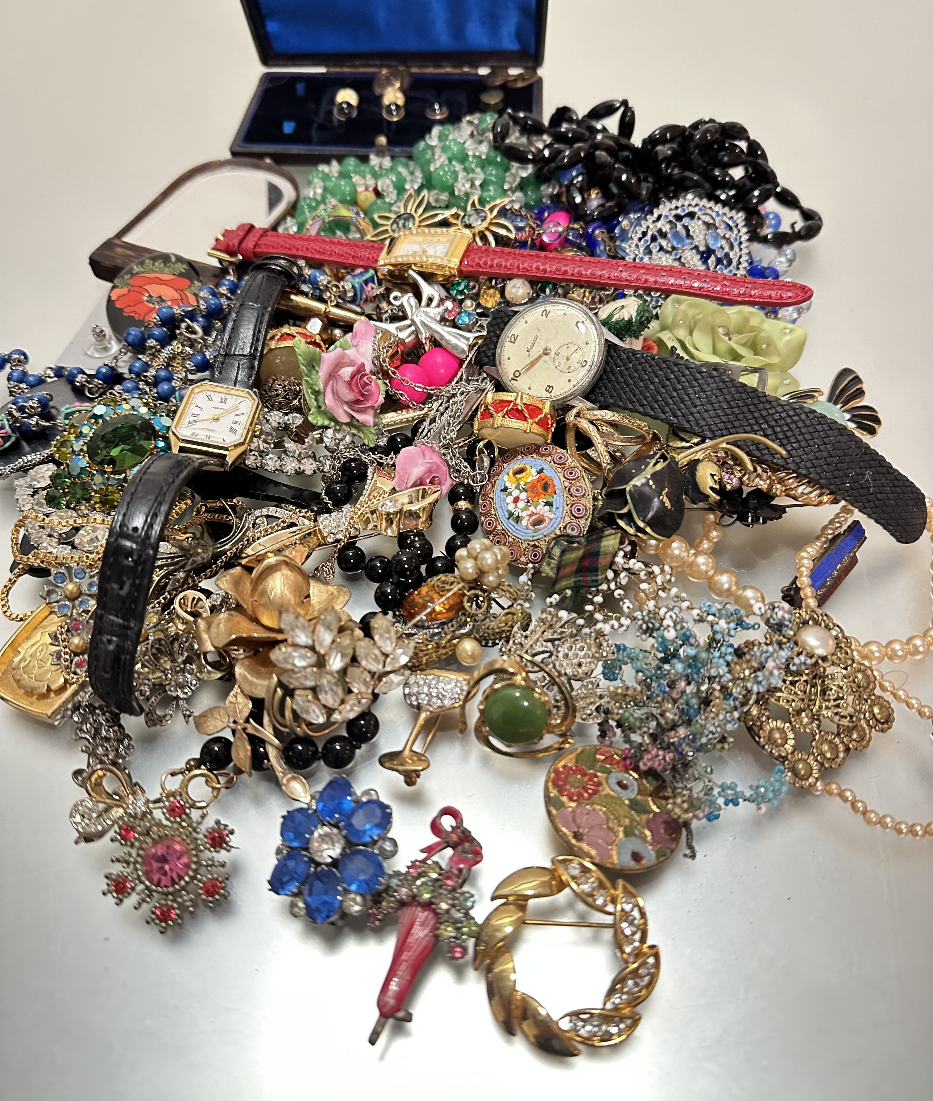 A large collection of costume jewellery including paste brooches, filigree brooches, enamel