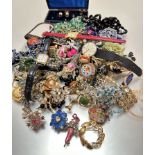 A large collection of costume jewellery including paste brooches, filigree brooches, enamel