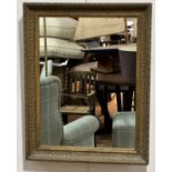 A rectangular gilt composition framed wall mirror, (h 127cm x 57cm)