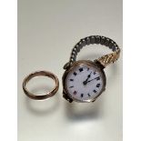 A Ladies vintage 9ct gold wristwatch with enamel dial and roman numerals on expanding metal bracelet