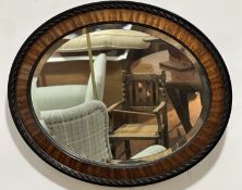 A 1920s mahogany and ebony bead and rope pattern bordered wall mirror with bevelled glass plate, (