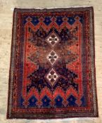 A Hand knotted North West Persian rug, with triple lozenge medallion on blue geometric field with
