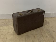 A circa 1930s travelling suitcase with brass locks and swing handle, W67cm