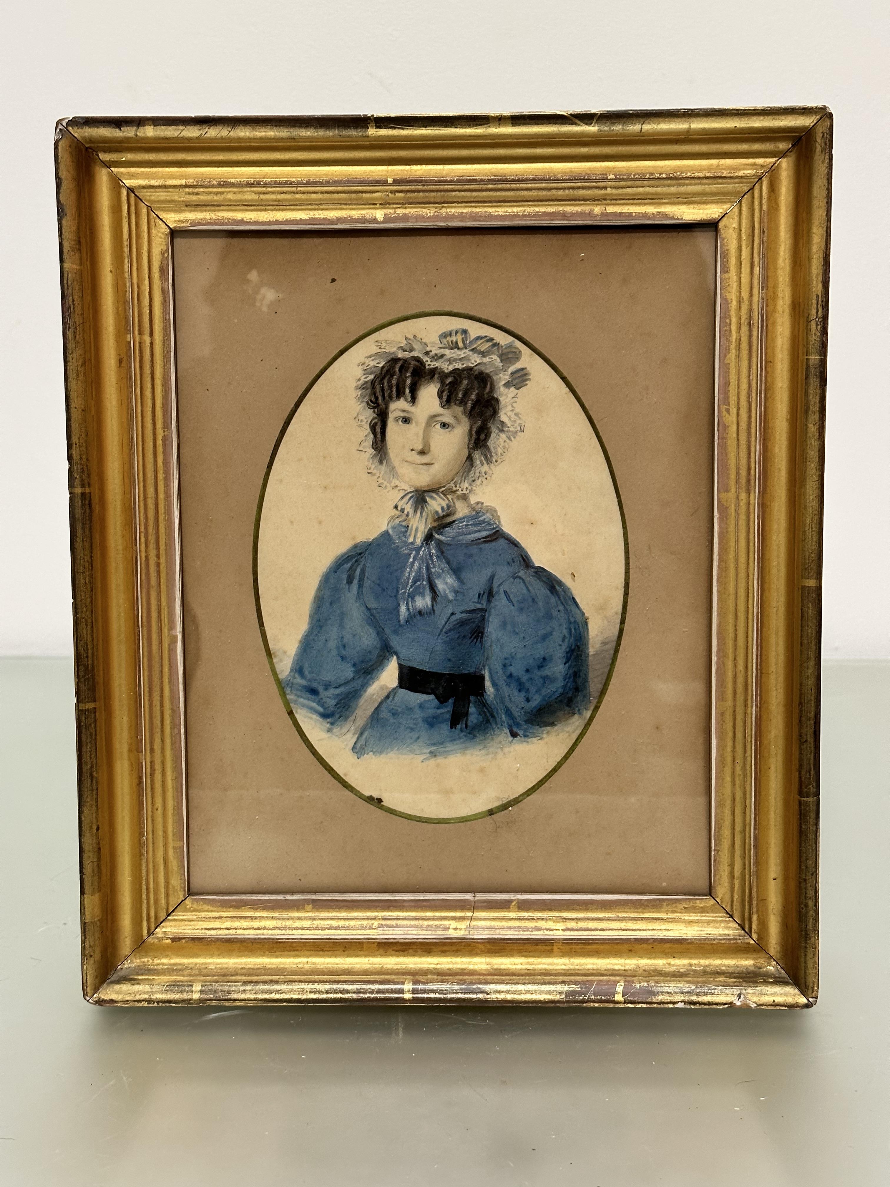 An early 19thc portrait of a young lady with blue and white ribbons, a ribboned lace hat and blue