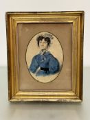 An early 19thc portrait of a young lady with blue and white ribbons, a ribboned lace hat and blue