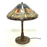 A modern bronzed verdigris finished Tiffany style lamp with dragon fly leaded glass conical shade,