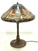 A modern bronzed verdigris finished Tiffany style lamp with dragon fly leaded glass conical shade,