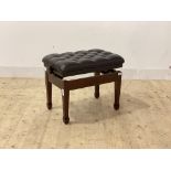 A modern piano stool, the rise and fall top upholstered in deep buttoned leather, raised on square