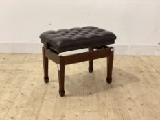 A modern piano stool, the rise and fall top upholstered in deep buttoned leather, raised on square