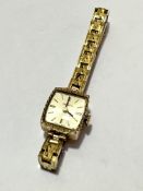 A lady's Helvetia 9ct gold rectangular shaped wrist watch with baton hour markers on a gilt metal