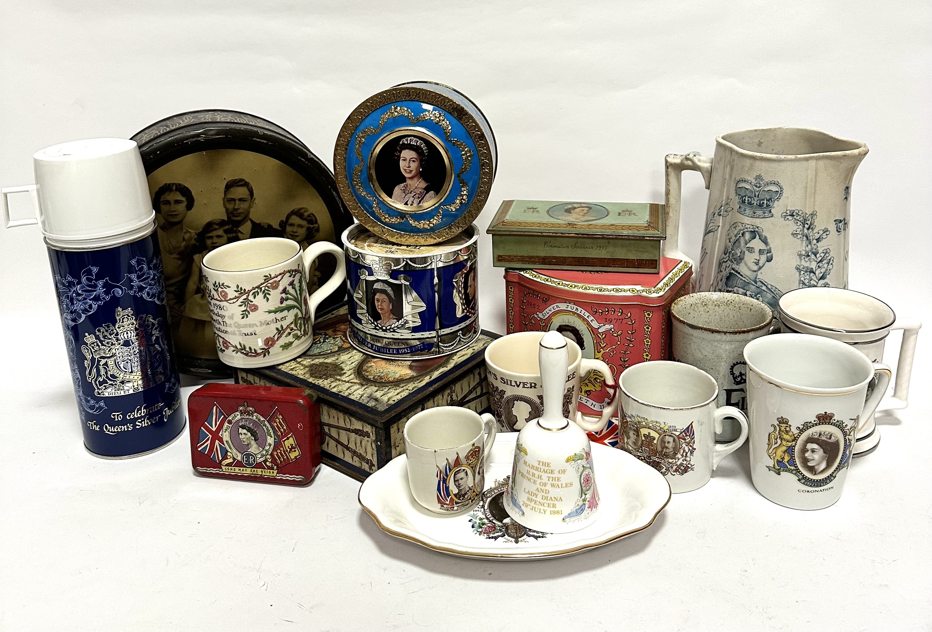 A collection of commemorative ware including tins, mugs, bell, dish, flask, jugs etc