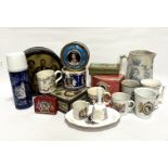 A collection of commemorative ware including tins, mugs, bell, dish, flask, jugs etc