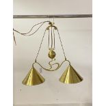 A brass Art Nouveau design rise and fall ceiling light fitting, with two conical shades, W80cm