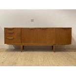 McIntosh, A mid century teak sideboard, with a fall front cocktail cupboard, twin cupboard and three