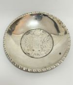 An Austrian Thaler 1780 inset into a white metal 800 stamped circular gadroon rimmed dish, (d :