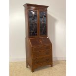 An Edwardian inlaid mahogany bureau bookcase, the top with two astragal glazed doors enclosing two