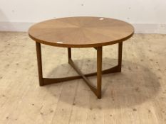 McIntosh, A mid century teak circular coffee table, the segmented top on turned supports united by a