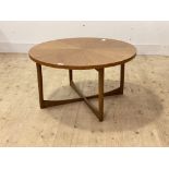 McIntosh, A mid century teak circular coffee table, the segmented top on turned supports united by a