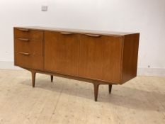 Mcintosh, A mid century teak sideboard, with twin doors enclosing a shelf, flanked by three drawers,