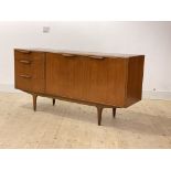 Mcintosh, A mid century teak sideboard, with twin doors enclosing a shelf, flanked by three drawers,