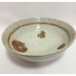 An exceptionally large pottery bowl, with internal brown double ring and patches of iron oxide,