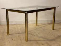 A vintage post modern dining table, circa 1970's, the rectangular glass top raised on gilt and